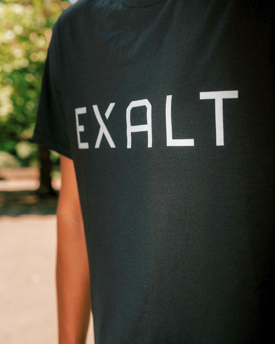 Close up shot of EXALT logo on the Black EXALT x Lululemon Fundamental Tee.