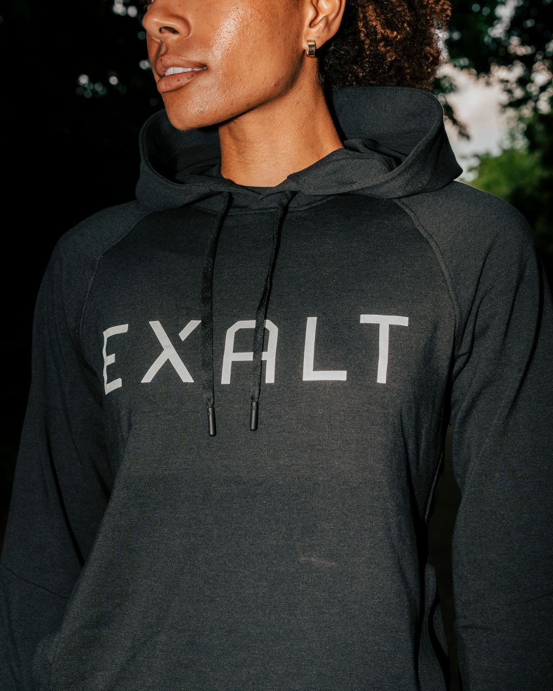 Close up shot EXALT White logo on the  Black EXALT x Lululemon City Sweat Hoodie.